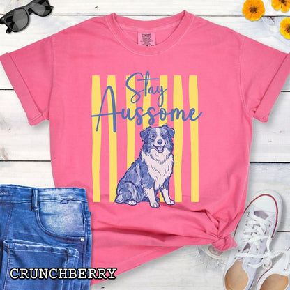 Pink Comfort Colors Australian Shepherd t-shirt featuring Stay Aussome slogan with cute blue merle Aussie illustration, perfect for Aussie moms, herding dog lovers, and Australian Shepherd gifts.