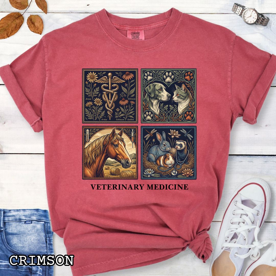 Red Comfort Colors t-shirt with vintage linocut-style veterinary-themed design in four panels and the text 'Veterinary Medicine', shown on a wooden surface with jeans and flowers.