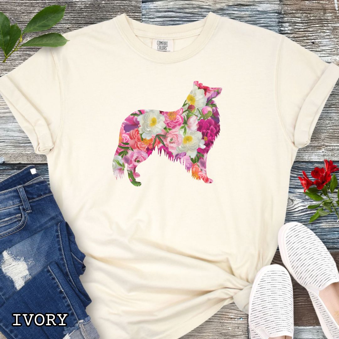 Beige Comfort Colors t-shirt for Collie lovers with floral Rough Collie dog design, shown on a wooden surface with jeans and flowers.