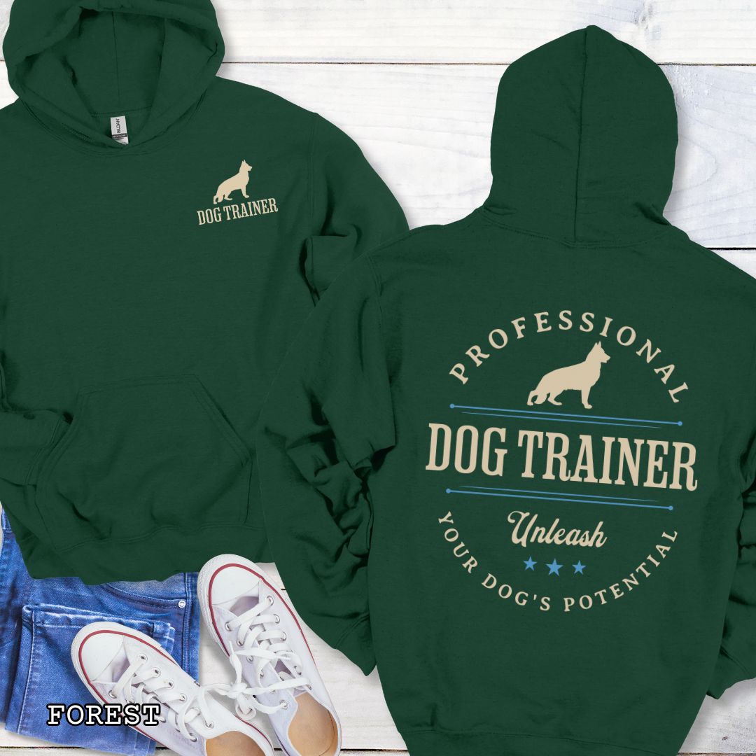 Front and back view of a forest green dog training hoodie with the text 'PROFESSIONAL DOG TRAINER, Unleash Your Dog's Potential"' and custom dog breed silhouette in a vintage, badge style design. The shirt is displayed flat with a pair of blue jeans and white shoes.