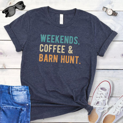 Heather navy dog sports t-shirt with 'Weekends, Coffee & Barn Hunt' in bold, colorful text, presented on a wooden surface with jeans and shoes.