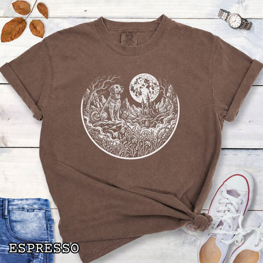 Brown Comfort Colors t-shirt featuring a Gothic moonlit scene with dog, castle and graveyard in vintage woodcut style, perfect for spooky dog lovers and Halloween dog enthusiasts.