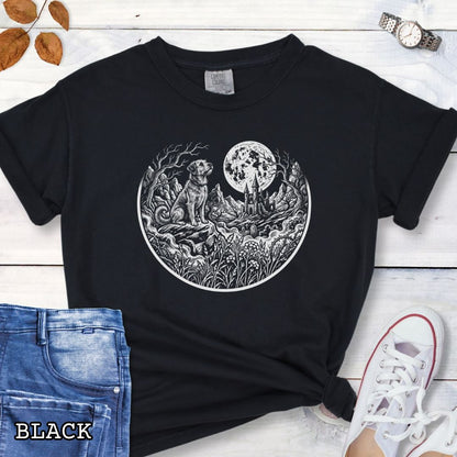 Black Comfort Colors t-shirt featuring a Gothic moonlit scene with dog, castle and graveyard in vintage woodcut style, perfect for spooky dog lovers and Halloween dog enthusiasts.