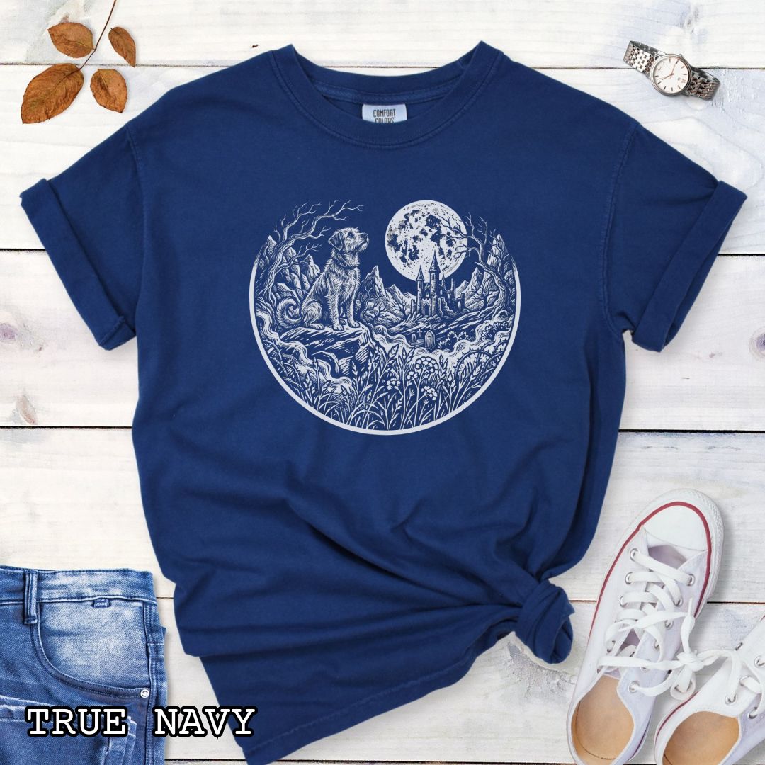Navy blue Comfort Colors t-shirt featuring a Gothic moonlit scene with dog, castle and graveyard in vintage woodcut style, perfect for spooky dog lovers and Halloween dog enthusiasts.