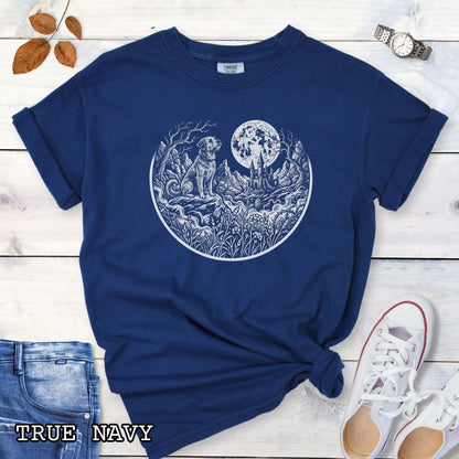 Navy blue Comfort Colors t-shirt featuring a Gothic moonlit scene with dog, castle and graveyard in vintage woodcut style, perfect for spooky dog lovers and Halloween dog enthusiasts.