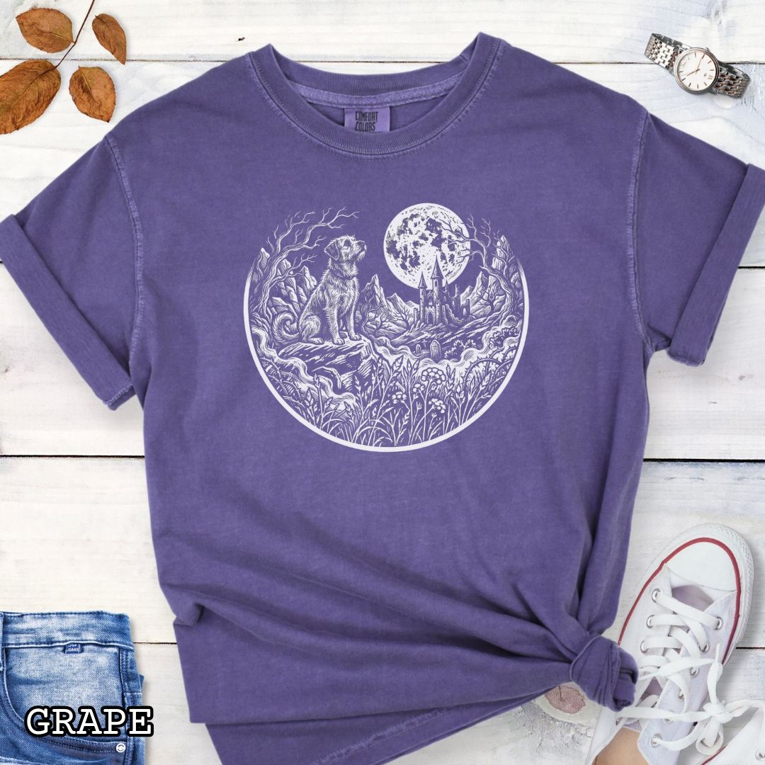 Purple Comfort Colors t-shirt featuring a Gothic moonlit scene with dog, castle and graveyard in vintage woodcut style, perfect for spooky dog lovers and Halloween dog enthusiasts.