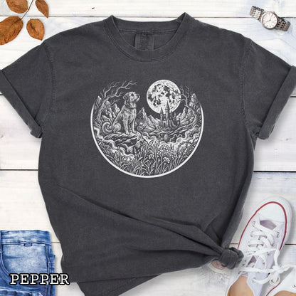 Dark grey Comfort Colors t-shirt featuring a Gothic moonlit scene with dog, castle and graveyard in vintage woodcut style, perfect for spooky dog lovers and Halloween dog enthusiasts.